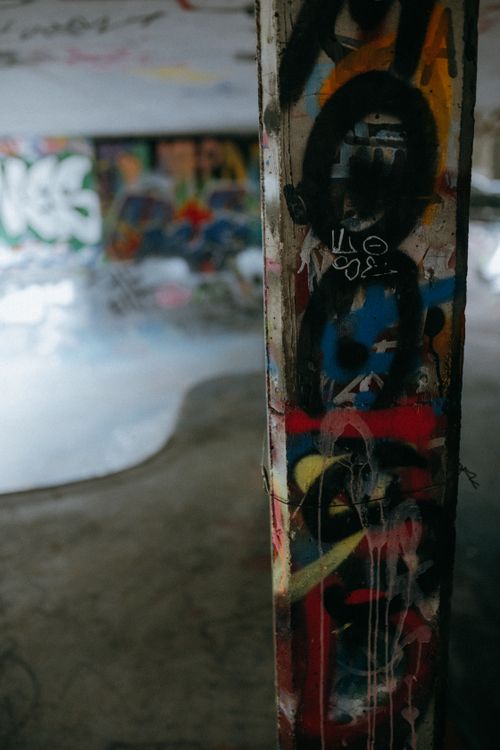Free Colorful graffiti art on pillars in an abandoned urban environment, showcasing street culture. Stock Photo
