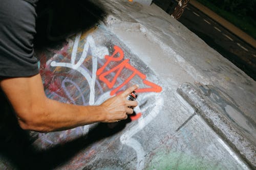 Man painting graffiti on wall 