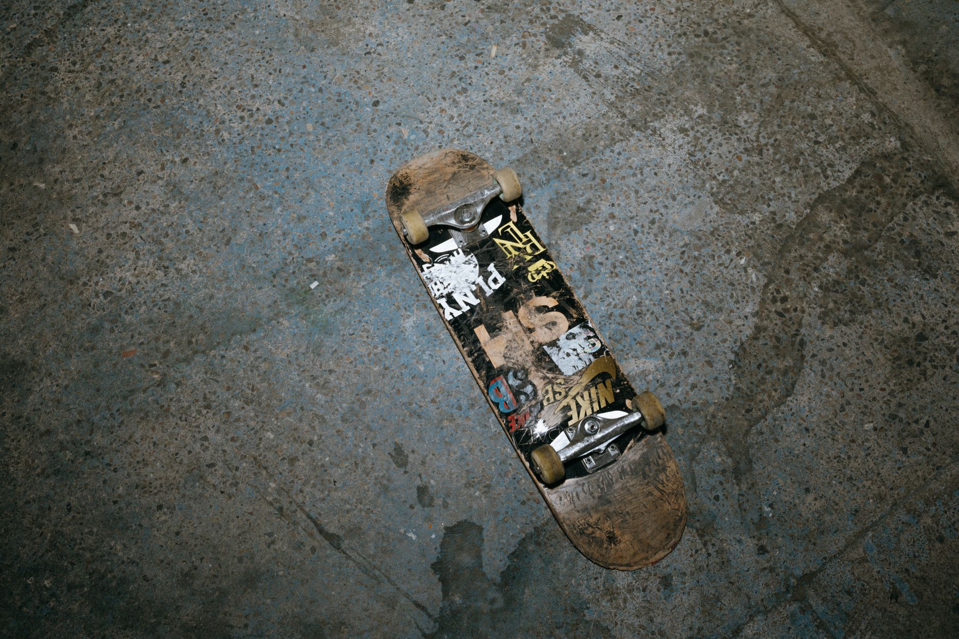 Skateboard collector measuring an old deck width with calipers in a quiet Houston workshop