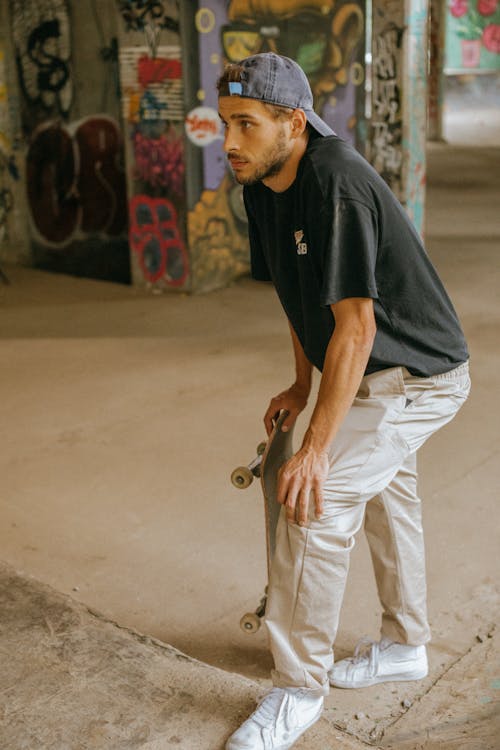 Young man standing with skateboard