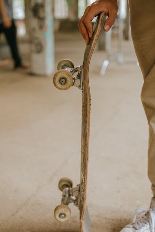 Person holding skateboard at skatepark