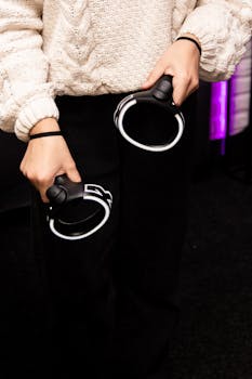 Close-up of hands holding modern VR controllers indoors.