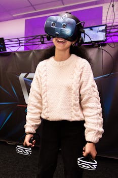 A young woman immersed in a virtual reality simulator indoors, smiling with VR headset.