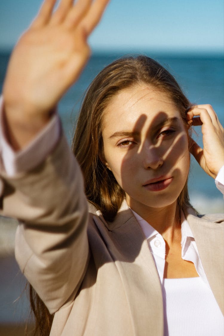 Woman Covering Face From Sunlight