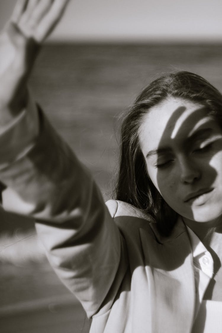 Woman Covering Face From Sunlight