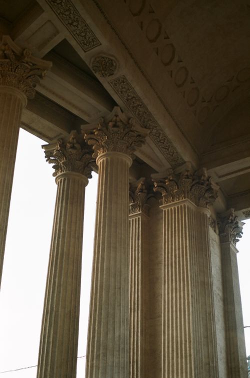 Free Close-up of intricately carved stone columns supporting a decorated ceiling in a classical architecture style. Stock Photo