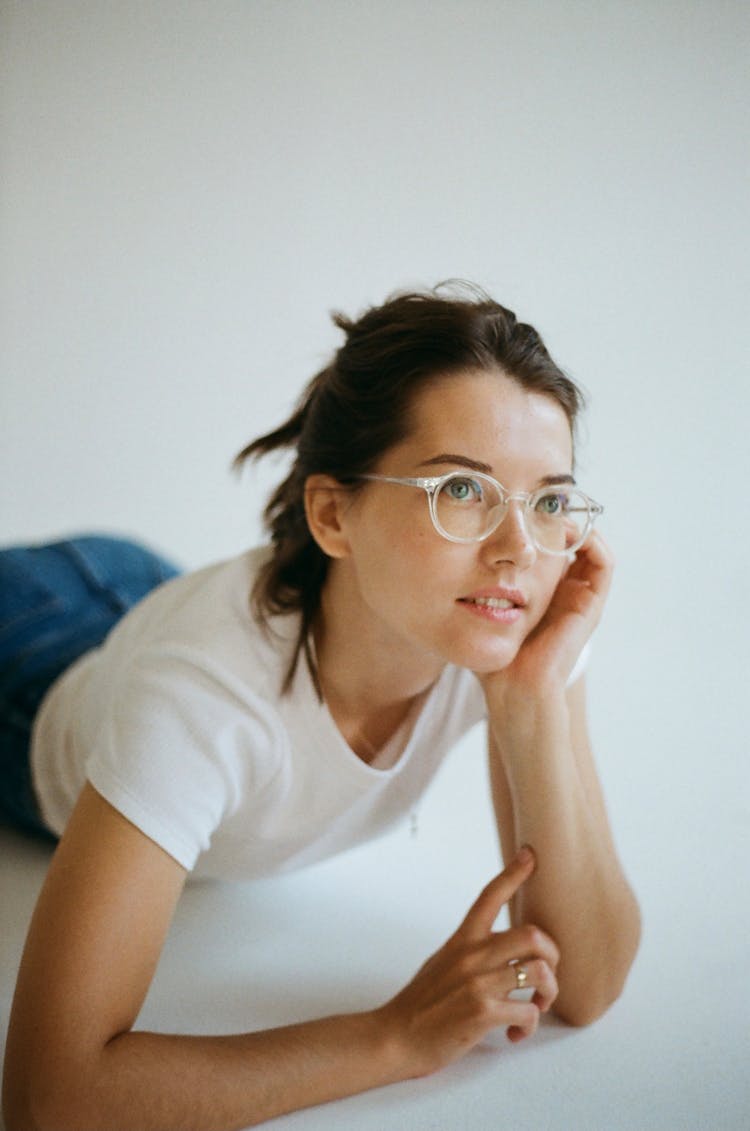 Young Woman Wearing Eyeglasses Laying Down