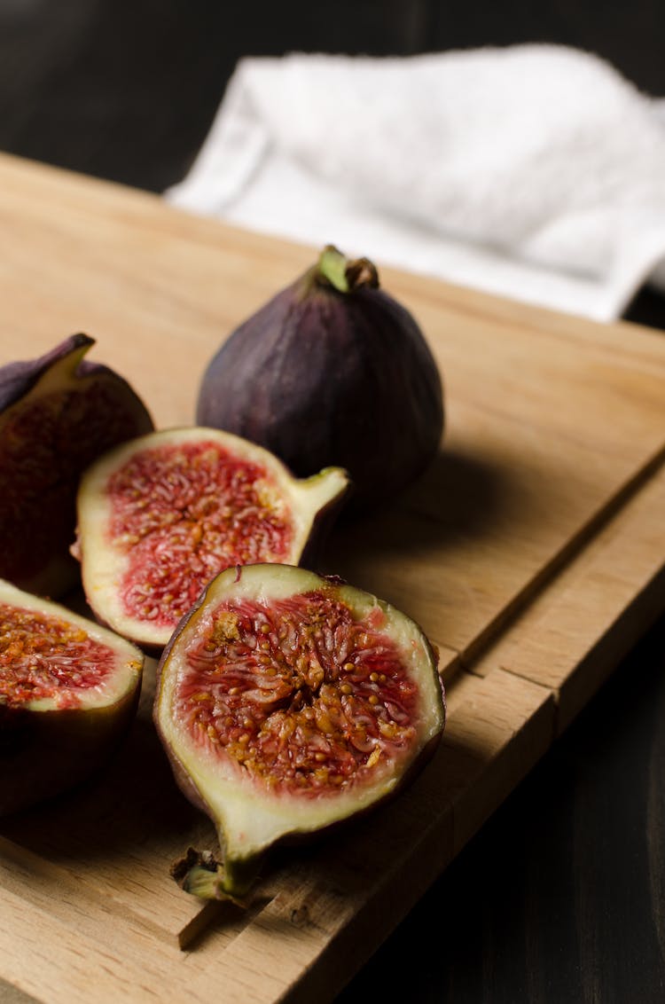 Sliced Figs On Wooden Chopping Board