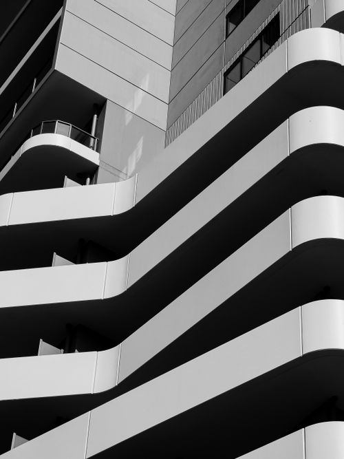 Free Sleek modern architecture featuring striking curved balconies in monochrome. Stock Photo
