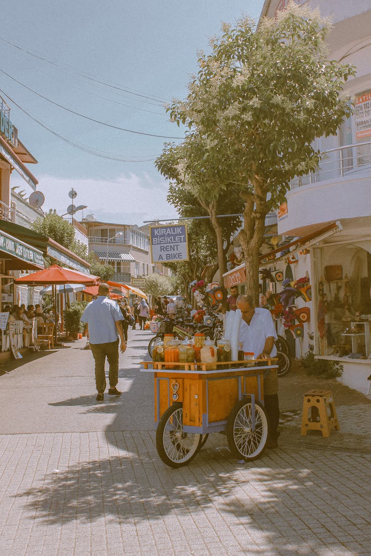 A Street Vendor With A Food Cart 