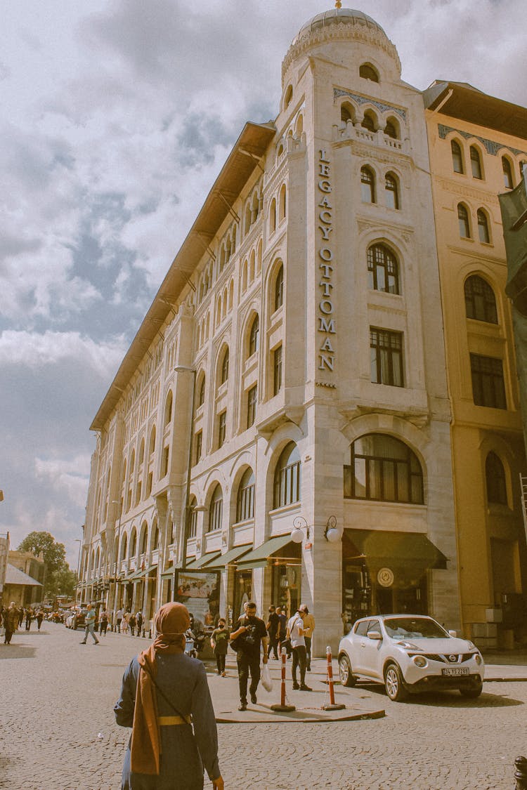 Pedestrians Walking In Front Of The Legacy Ottoman Luxury Hotel