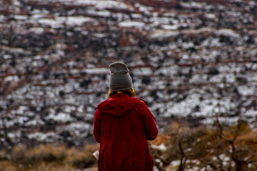 Back View of a Person in Red Jacket and Wearing Beanie Hat
