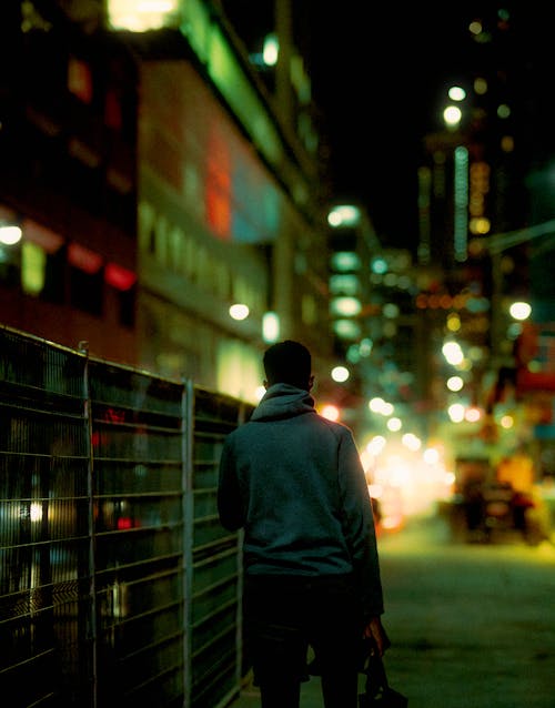 A Person Wearing a Hoodie at Night