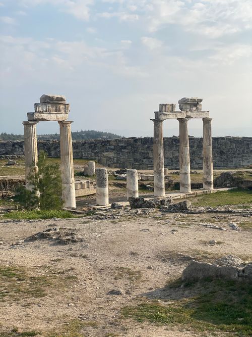 Free Explore ancient Roman ruins with prominent stone columns under a vast sky. Stock Photo
