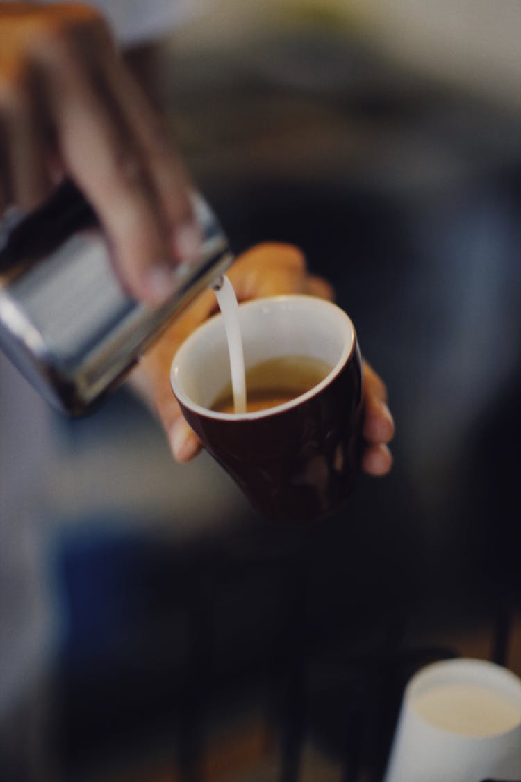 Pouring Milk To Tea