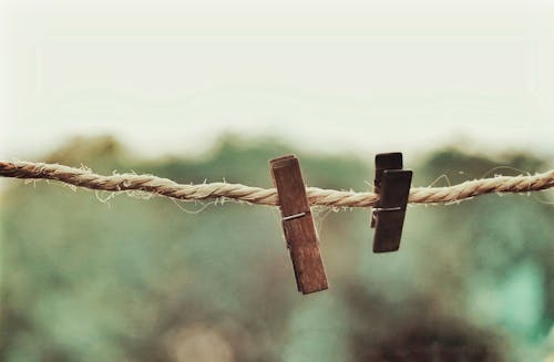 Wooden Clothespins in a Brown Rope