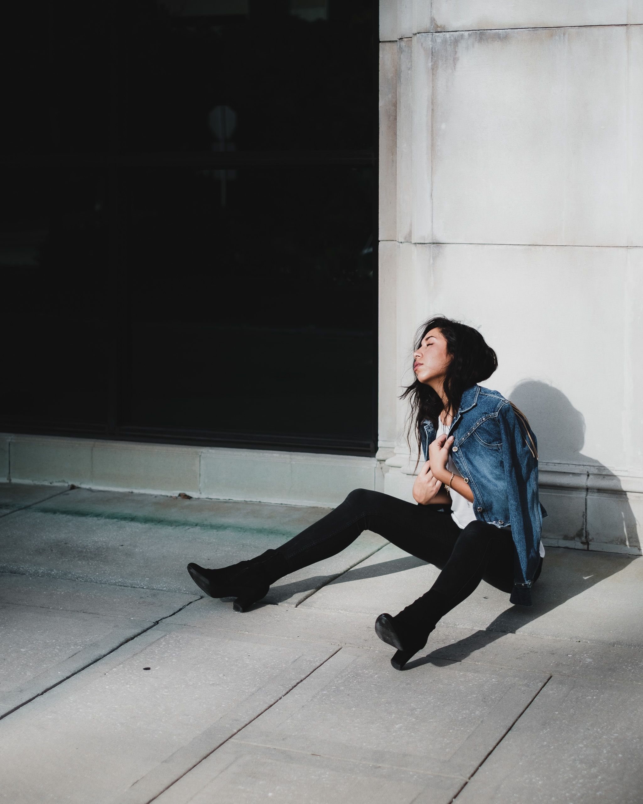 A Woman Wearing a Denim Jacket Sitting on the Ground · Free Stock Photo