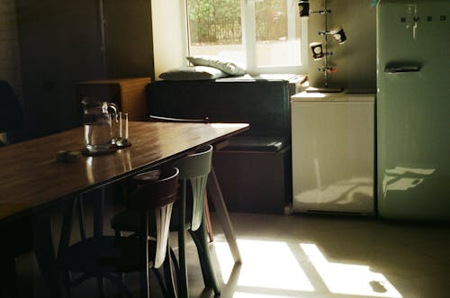 Rectangular Brown Wooden Table and Two Chairs