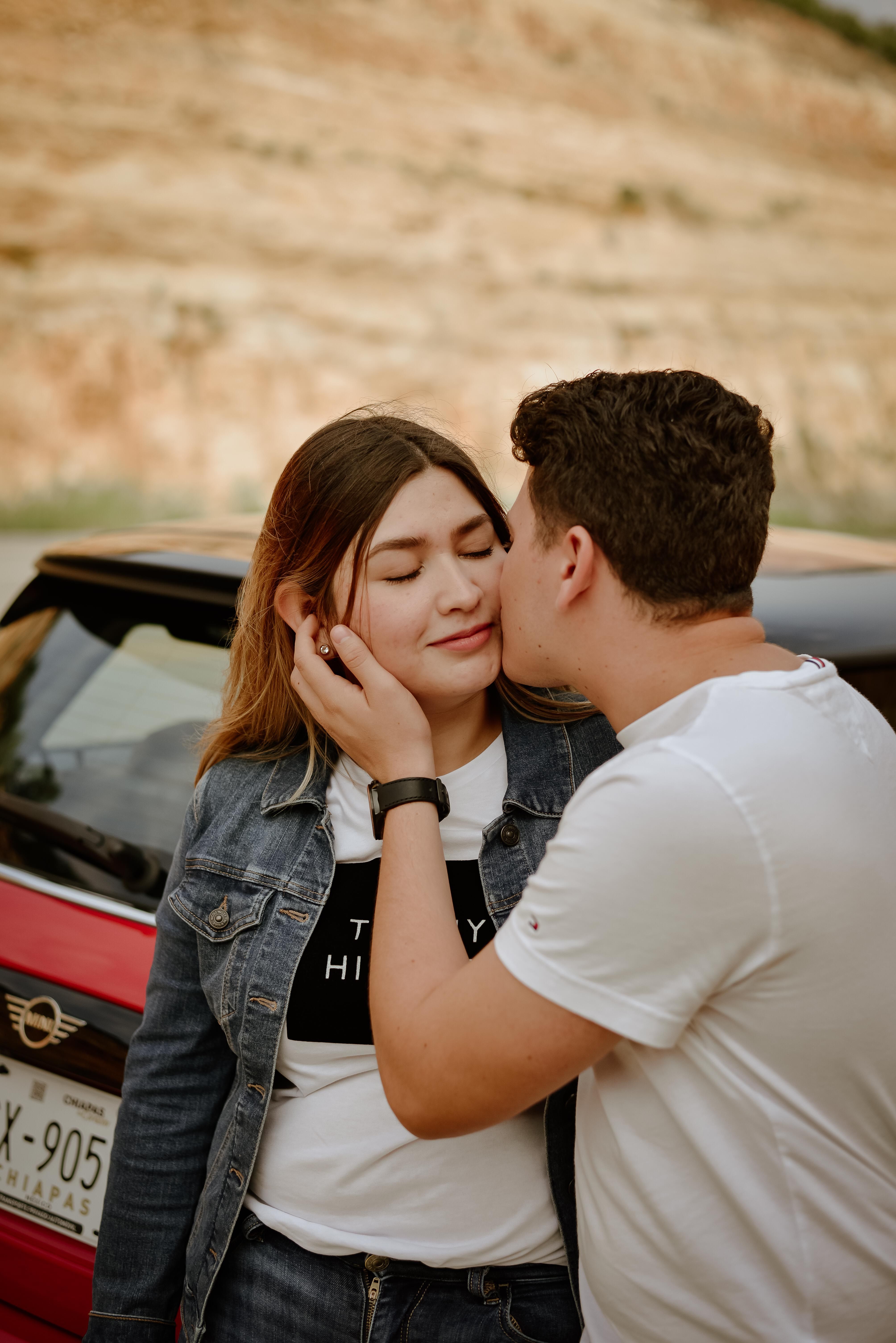 Man in White T-shirt Kissing Woman in Blue Denim Jacket · Free Stock Photo