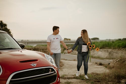 Man and Woman Holding Hands While Walking