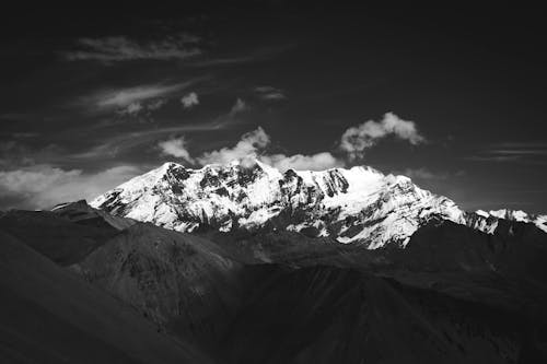 Grayscale Photo of Snow Covered Mountains