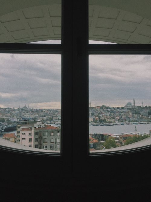Free Stunning view of İstanbul skyline from an arched window, showcasing city architecture. Stock Photo