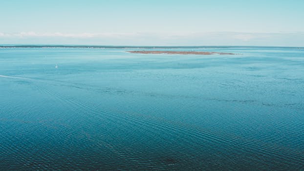A beautiful aerial view of Arcachon Bay, showcasing tranquil blue waters and distant shores.