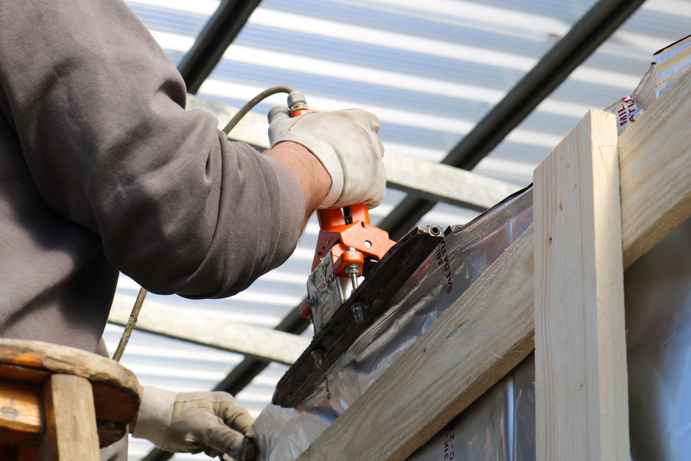 Construction worker hand-fastening on a residential project