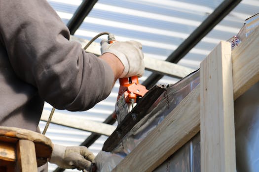 A construction worker using a power tool on a building project in Treviso, Italy.