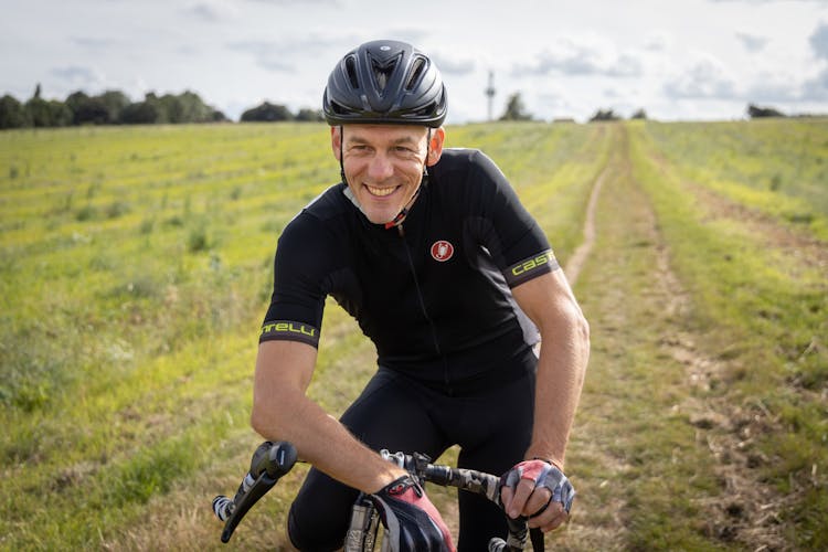 Adult Cyclist Smiling On Field