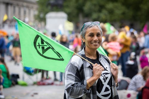 Elder woman with green banner