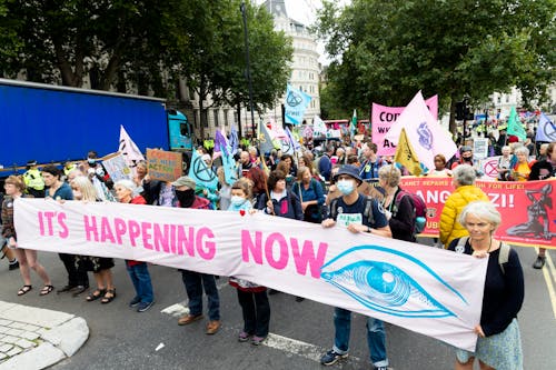 Free Demonstration of people wearing masks with placards and banners Stock Photo