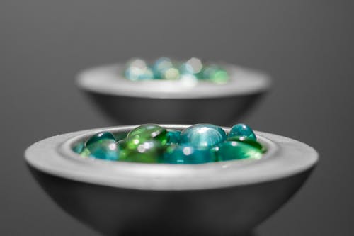 Multicolored Pebbles on White Ceramic Bowl