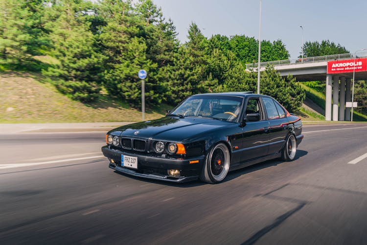 Person Driving A Black Bmw 5 Series