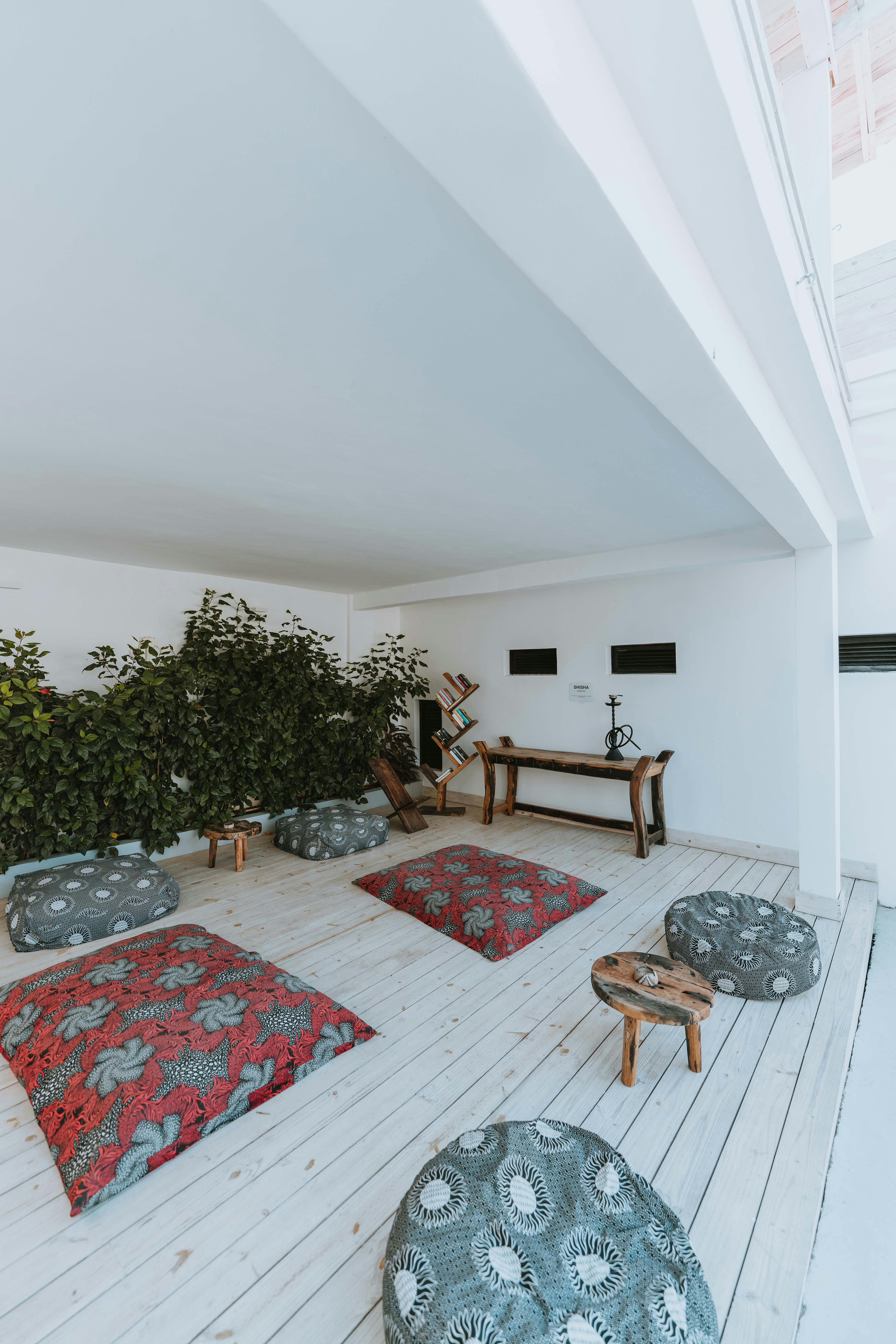 Spacious minimalist indoor lounge with vibrant decor and comfortable seating in a modern apartment.