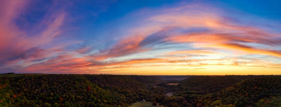 A captivating sunset with vibrant skies over lush green valleys in Minnesota.