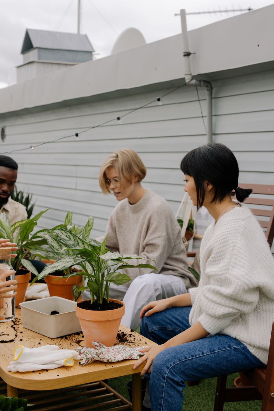 Our gardening team potting plants together outdoors