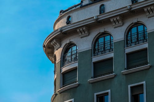 Free Low-angle Photography of Green and Beige Concrete Building Stock Photo