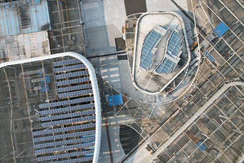 Free Aerial view of modern rooftops with solar panels in Wuxi, Jiangsu, China. Renewable energy focus. Stock Photo