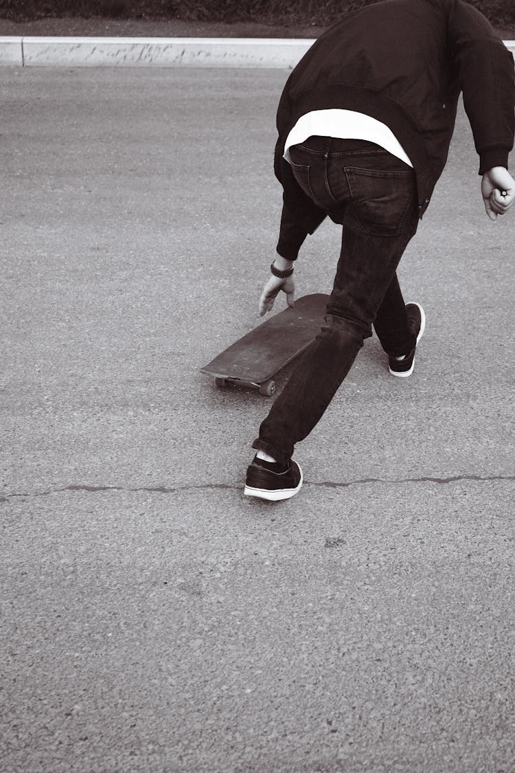 A Person Getting A Skateboard