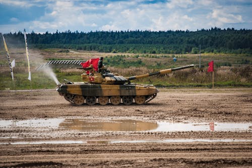 Soldiers on Tank in Field