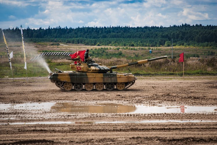 Soldiers On Tank In Field