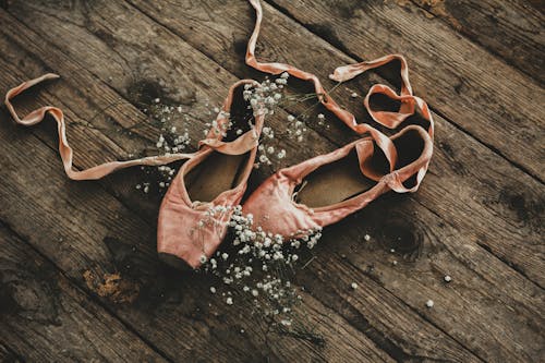 Free Ballet Shoes on Wooden Floor Stock Photo