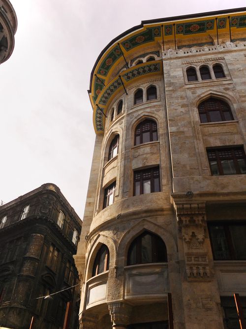 Free Low angle view of a historic building with arched windows and detailed facade. Stock Photo