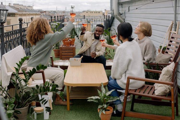 People Drinking Wine On House Veranda