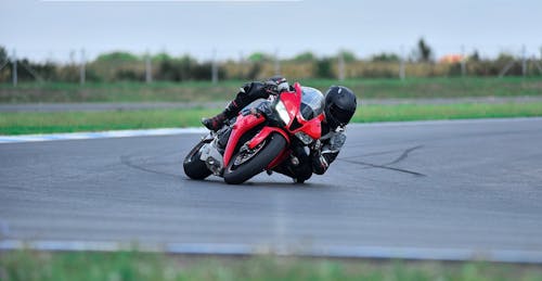 Man Riding a Red Motorcycle