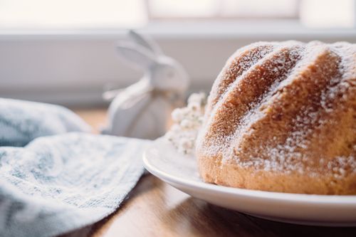 Free Delicious freshly baked cake with sugar dusting on a cozy kitchen table. Stock Photo
