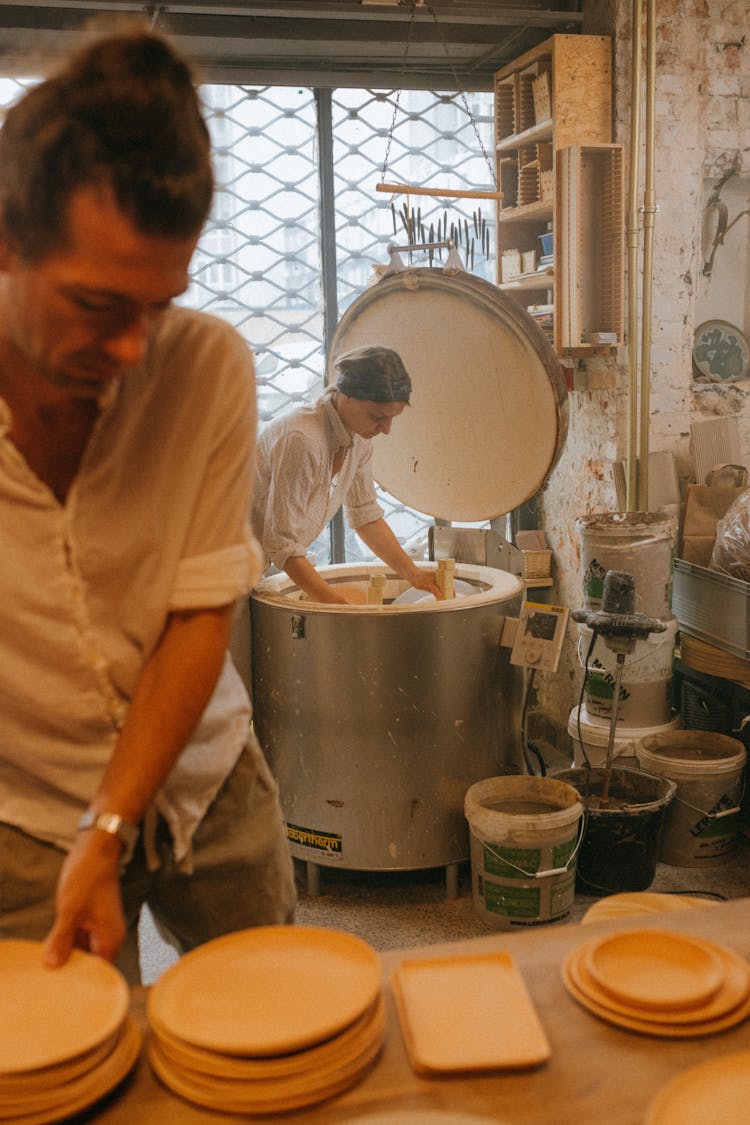 People Working In Pottery Workshop