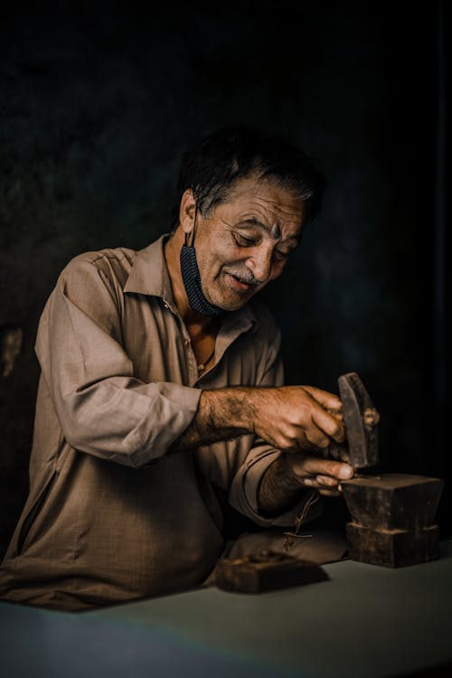 An Elderly Man Holding a Hammer