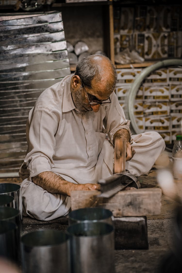 Man Hammering A Sheet Metal